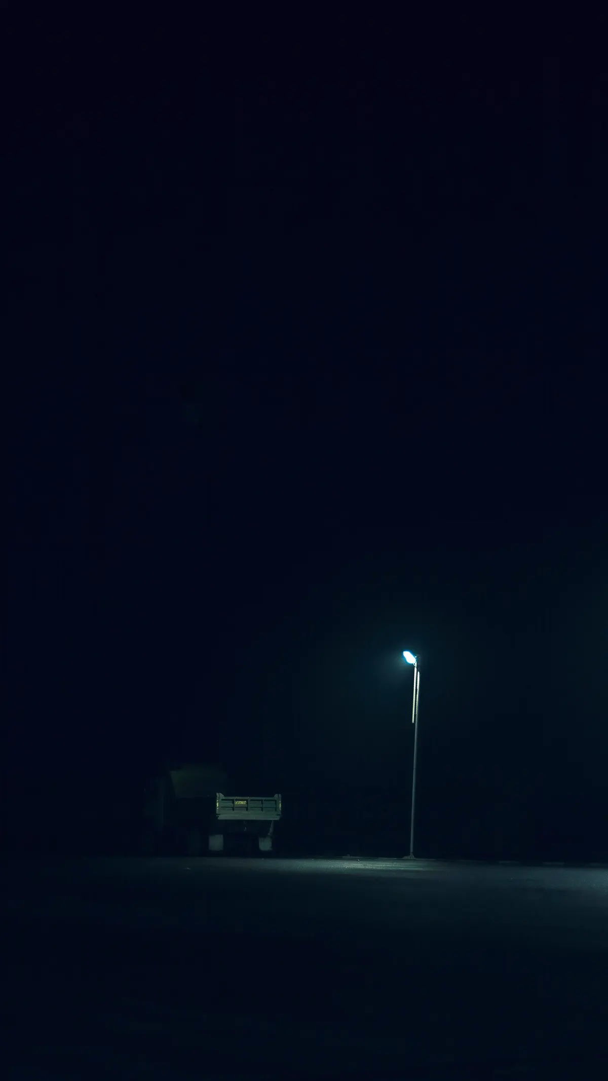 Freight truck under a street lamp at night