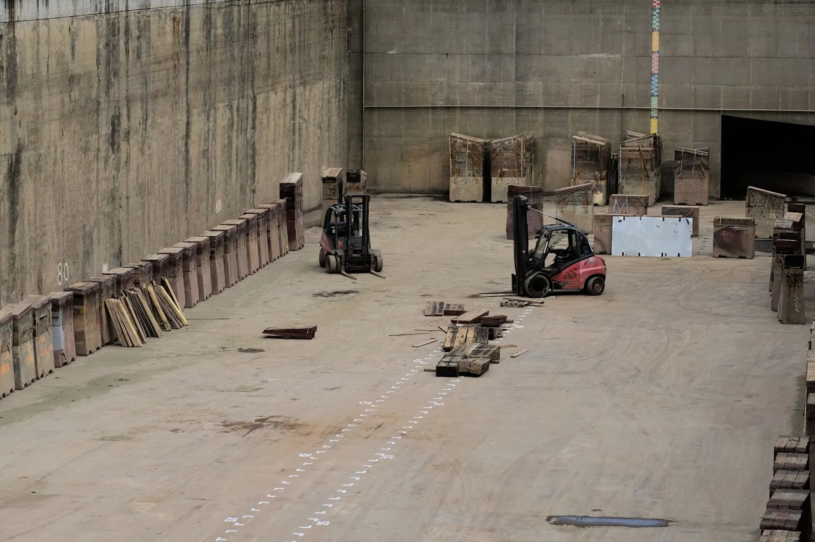Forklifts moving pallets inside a freight warehouse